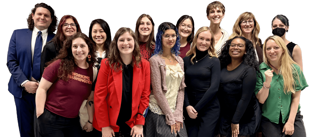 Fourteen people smiling and looking at the camera